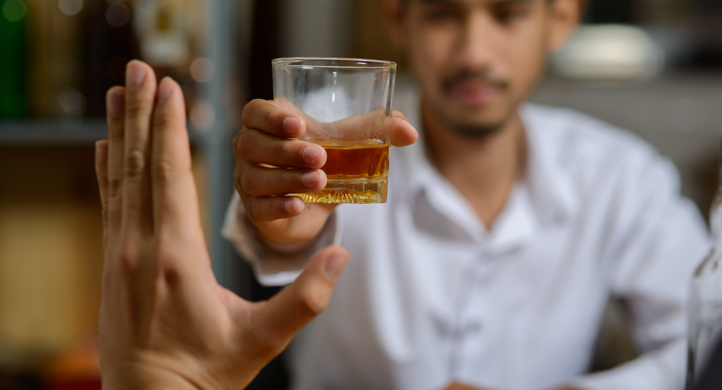 Person pushing drink away